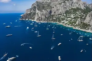 Aerial drone shot view of southern coastline of Capri Islan in Tyrrhenian sea with luxury yachts