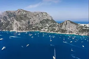 Faraglioni Prints: Aerial drone shot view of southern coastline of Capri Islan in Tyrrhenian sea with yachts