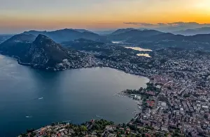 Aerial Cityscape Prints: Aerial drone shot view before sunset of Swiss city Lugano and Monte Salvatore by Lago di lugano