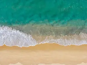 Aerial Drone view beautiful empty beach. Top view wave from sea come to beach. With copy space