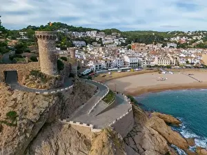 Costa Brava Prints: Aerial drone view of the coastal town named Tossa de Mar with a beach and castle