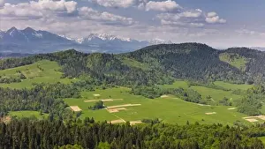 Tatra Prints: Aerial drone view over green hills of Pieniny National Park and snowy Tatra Mountains