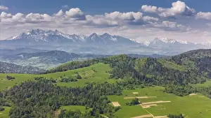 Tatra Prints: Aerial drone view over green hills of Pieniny National Park and snowy Tatra Mountains