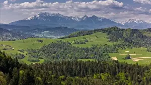 Tatra Prints: Aerial drone view over green hills of Pieniny National Park and snowy Tatra Mountains