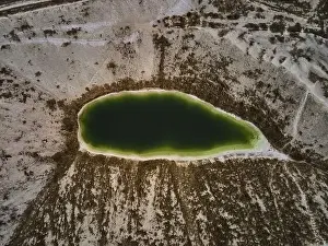 Emissions Prints: Aerial drone view a green lake formed on phosphogypsum waste