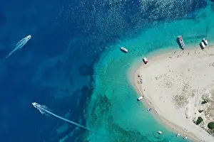 Aerial drone view of iconic small uninhabited island of Marathonisi featuring clear water, sandy shore and natural hatchery of Caretta-Caretta sea tur