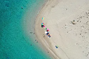Aerial drone view of iconic small uninhabited island of Marathonisi featuring clear water, sandy shore and natural hatchery of Caretta-Caretta sea tur
