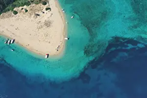 Aerial drone view of iconic small uninhabited island of Marathonisi featuring clear water sandy shore and natural hatchery of Caretta-Caretta sea turt