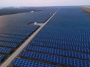 48mp Prints: Aerial drone view of large solar panels at a solar farm at bright spring windy sunset