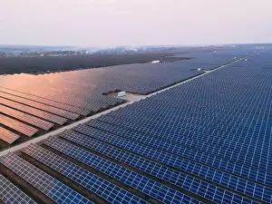 48mp Prints: Aerial drone view of large solar panels at a solar farm at bright spring windy sunset