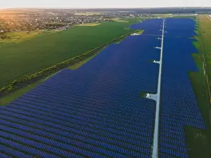 48mp Prints: Aerial drone view of large solar panels at a solar farm at bright summer sunset