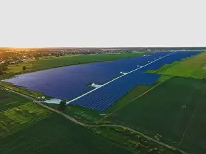 48mp Prints: Aerial drone view of large solar panels at a solar farm at bright summer sunset