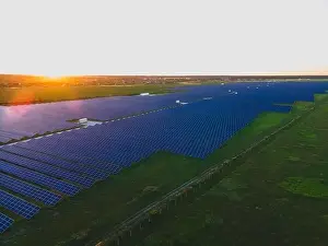 48mp Prints: Aerial drone view of large solar panels at a solar farm at bright summer sunset