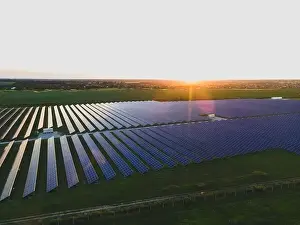 48mp Prints: Aerial drone view of large solar panels at a solar farm at bright summer sunset