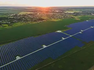 48mp Prints: Aerial drone view of large solar panels at a solar farm at bright summer sunset