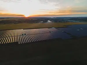 Solar Farm Prints: Aerial drone view into large solar panels at a solar farm in large field on countryside at bright sunset