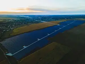 Solar Farm Prints: Aerial drone view into large solar panels at a solar farm in large field on countryside at bright sunset
