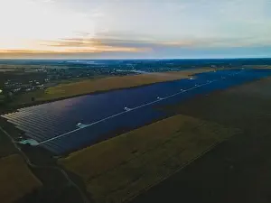 Solar Farm Prints: Aerial drone view into large solar panels at a solar farm in large field on countryside at bright sunset