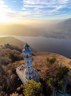 Lago Prints: Aerial drone view of a lighthouse over Lake Como skyline with sunset light - Faro Voltiano (Volta Lighthouse)