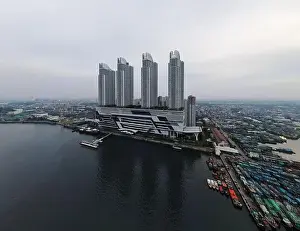Wooden Boat Prints: Aerial drone view of Muara Angke Beach with wooden boats leaning beside the pier