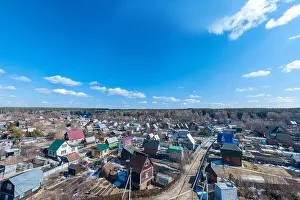 Aerial drone view of an old traditiona village in the forest, on background bly sky