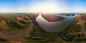 Aerial drone view of river landscape in sunny summer evening