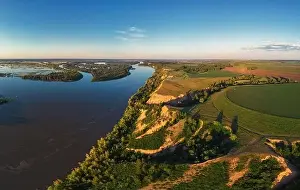 Aerial drone view of river landscape in sunny summer evening