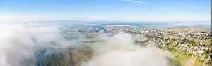 Establishing Shot Prints: Aerial drone view of scenic countryside in autumn sunny and misty day