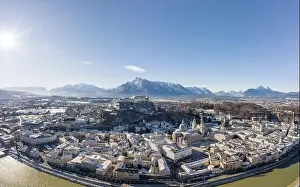 Salzach Prints: Aerial drone view of snowy Hohensalzburg fortress with view of Unesberg mountain in winter morning