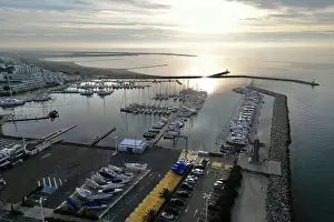 Aerial drone view of the sunset over the port and marina in Port Camargue, Occitanie, France