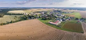 Harvester Prints: Aerial: Fields near village, stubble with straw bales at late summer. Drone landscape
