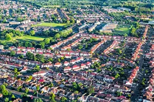 Aerial high angle bird's eye view from airplane over city of London in United Kingdom with terraced houses buildings