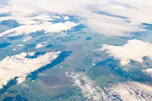 Windfarm Prints: Aerial above high angle view from airplane over United Kingdom countryside with farm fields and wind turbines