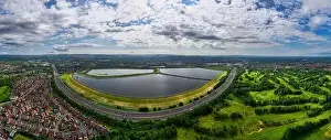 Calm Waters Prints: Aerial image of Audenshaw reservoirs and M60 Manchester outer ring road next to it