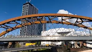 High Rise Buildings Prints: Aerial image of Ordsall Chord rail-bridge and the footbridge in Manchester UK