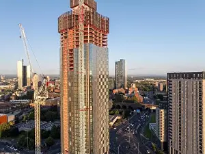 Aerial image of Trinity Islands skyscraper cluster in Manchester UK and Manchester skyline on the background