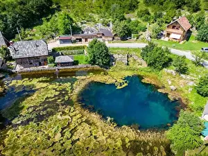 Drone Perspective Prints: Aerial image of Wonderful Majerovo Vrilo wooden houses and Gacka river source in the village of Sinac