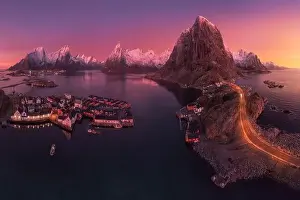 Boat Building Prints: Aerial landscape of calm river and rocky formations located in Hamnoy under sunset sky in evening