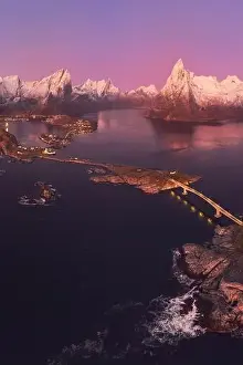 Boat Building Prints: Aerial landscape of calm river and rocky formations located in Hamnoy under sunset sky in evening