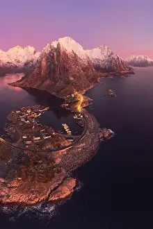 Boat Building Prints: Aerial landscape of calm river and rocky formations located in Hamnoy under sunset sky in evening