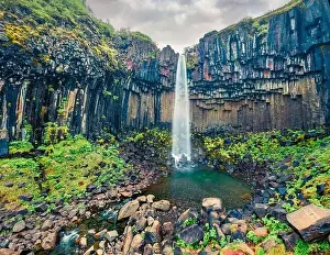 Aerial landscape photography. Fresh green view from flying drone of famous Svartifoss Waterfall