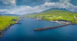 Vagar Prints: Aerial landscape photography. Gloomy summer view from flying drone of Sandavagur village