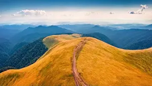 Aerial landscape photography. Impressive summer scene with old country road on Menchul ridge
