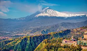 Aerial landscape photography. Picturesque morning view of Taormina town and Etna volcano on background