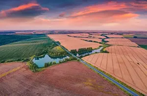 Aerial landscape photography. Spectacular summer sunset on the Ternopil outskirts with two lakes and asphalt road