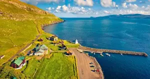 Faroe Island Prints: Aerial landscape photography. Sunny morning view from flying drone of Kirkjubour village