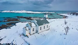 Aerial landscape photography. View from flying drone of Gimsoy Church, Norway, Europe. Gloomy winter scene of Lofoten Islands. Picturesque morning sea