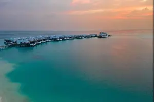 Maldives Island Prints: Aerial Maldives island sunset. Water bungalows resort at islands beach
