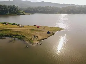 Forest Green Prints: Aerial morning view of camping ground area by the Sermo Lake with forest hill on the background in Kulonprogo