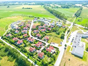 Aerial of new construction luxury residential neighborhood street single family homes real estate